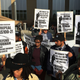 Takiyah Thompson (second from left), who was accused of helping to topple a Confederate statue, speaks to reporters as supporters hold signs in Durham, N.C., on Dec. 5, 2017. (Jonathan Drew/AP Images)